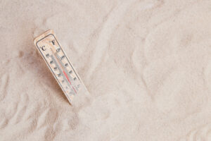 summer-composition-with-sand-thermometer