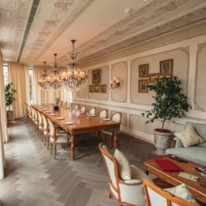  photo royal dining room with wooden furniture and chandeliers