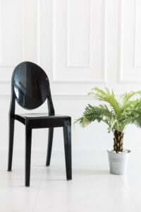 Empty Cheap Black Outdoor Chair with vase plant decoration in living room interior
