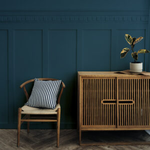 best craft furniture Scandinavian vintage wood cabinet with chair by a dark blue wall