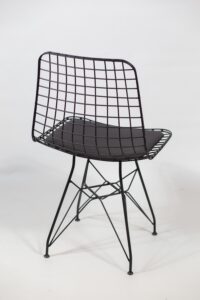 A vertical shot of a futuristic Cheap Black Outdoor Chair with a chain in the back behind a white background