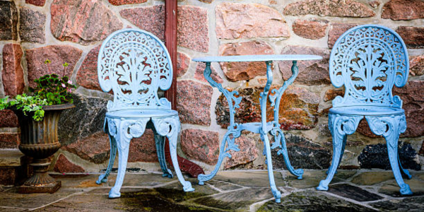 wrought iron Patio furniture against stone wall