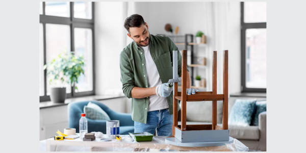 Man maintaining wrought iron patio furniture at home
